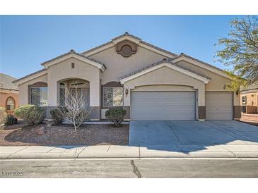 Charming single-story home featuring a three-car garage and well-maintained landscaping at 2617 Tanagrine Dr, North Las Vegas, NV 89084