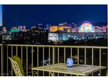 Balcony view showcasing the Las Vegas skyline at night with outdoor seating at 3111 Bel Air Dr # 12C, Las Vegas, NV 89109