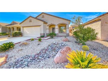 Charming single-story home with a desert-style landscaped front yard and a two car garage at 473 Elm Crest Pl, Henderson, NV 89012