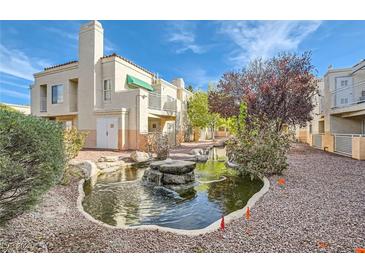 View of beautiful Laguna Del Rey grounds featuring garden landscaping, rock fountain, and building exteriors at 5000 Red Rock St # 105, Las Vegas, NV 89118