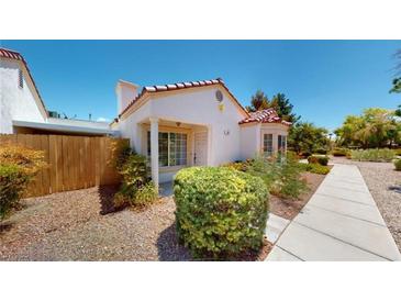 Charming single-story home with a landscaped front yard and a concrete pathway leading to the entrance at 5449 Bugle Way # 102, Las Vegas, NV 89108