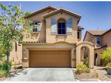 Charming two-story home featuring a two-car garage, arched entryway, and decorative window shutters at 7830 Shingle Beach St, Las Vegas, NV 89166