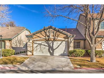 Charming home featuring a two-car garage, manicured lawn, and mature shade tree at 908 Majestic Oak St, Las Vegas, NV 89145