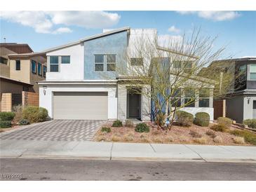 Stylish two-story home featuring a modern design, two-car garage, and well-maintained landscaping at 9690 Hiking Ave, Las Vegas, NV 89166