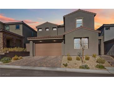 Contemporary two-story home boasts a neutral color palette, paver driveway and drought tolerant landscaping at 11548 Salt Creek Ave, Las Vegas, NV 89138