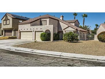 Charming home with mature landscaping, attached two-car garage and a well maintained lawn at 1804 Michael Ct, Henderson, NV 89014