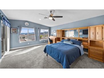Spacious bedroom features a ceiling fan, carpeted floor, and built in wooden storage at 262 Big Horn Dr, Boulder City, NV 89005