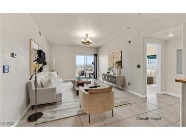 Bright living room features modern decor, stylish furnishings, and sliding glass doors to a balcony at 3550 Bay Sands Dr # 2087, Laughlin, NV 89029