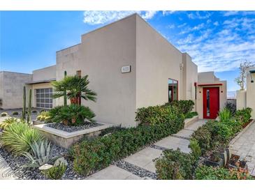 Modern home with desert landscaping, featuring a red door and decorative cacti at 431 Tranquil Peak Ct, Henderson, NV 89012