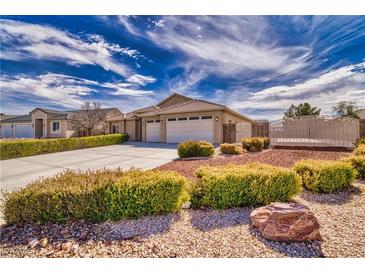 Charming single-story home with desert landscaping, spacious driveway, and a two-car garage at 5071 Andover Ct, Pahrump, NV 89061