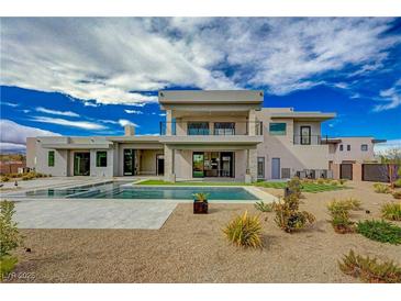 Beautiful backyard featuring a modern home, a swimming pool, and desert landscaping at 5880 Westwind Rd, Las Vegas, NV 89118