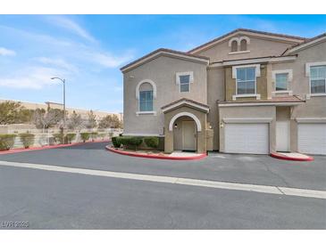 Inviting two-story townhome featuring a charming entrance and attached garages at 10001 Peace Way # 2352, Las Vegas, NV 89147