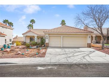 Charming single-story home featuring a well-manicured front yard and a two-car garage at 266 Corvallis Ct, Henderson, NV 89074