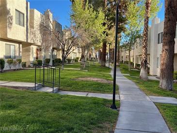 A nice exterior view of the building's lawn and the walking paths that go in between the residences at 2692 Matogroso Ln, Las Vegas, NV 89121