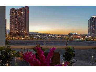 Enjoy breathtaking views of the Las Vegas skyline from this spacious balcony with decorative flowers at 2747 Paradise Rd # 404, Las Vegas, NV 89109