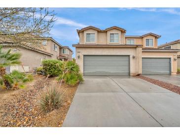 Charming two-story townhome featuring an attached two-car garage and low-maintenance landscaping at 3724 Thomas Patrick Ave, North Las Vegas, NV 89032