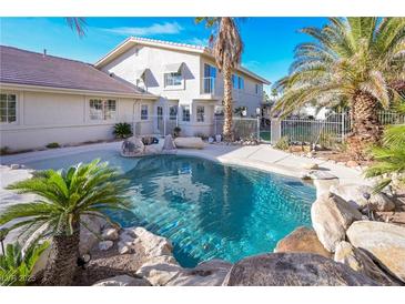 Backyard pool surrounded by rocks and palm trees providing a relaxing oasis for outdoor enjoyment at 788 Rossmore Dr, Las Vegas, NV 89110