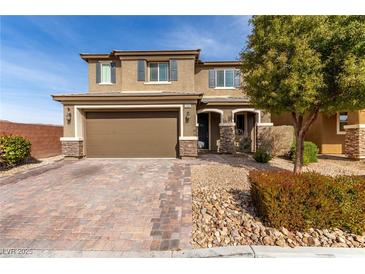 Two-story home with a two car garage and desert landscaping at 7884 Patagonia Point Ct, Las Vegas, NV 89179