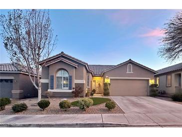 Charming single-story home featuring a well-manicured front yard and an attached two-car garage at 10217 Queens Church Ave, Las Vegas, NV 89135