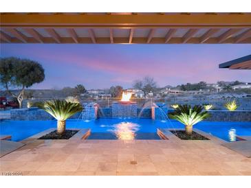 Stunning outdoor pool area with a water feature and fire pit offering the perfect spot for relaxation and entertainment at 12 Wade Hampton Trl, Henderson, NV 89052