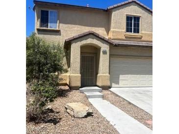 Two-story home showcasing a well-kept lawn and inviting entryway at 4039 Meadow Foxtail Dr, Las Vegas, NV 89122