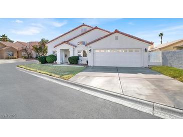 Inviting single-Gathering home featuring a well-manicured lawn and a two-car garage at 5049 Forest Oaks Dr, Las Vegas, NV 89149