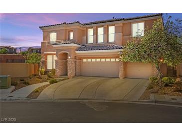 Elegant two-story home with a spacious three-car garage and beautiful desert landscaping at 505 Los Dolces St, Las Vegas, NV 89138