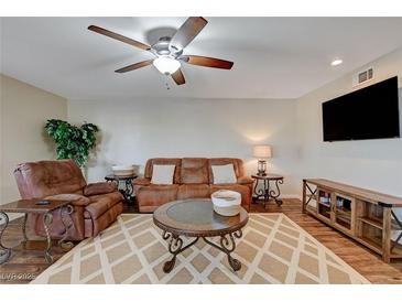 Comfortable living room with ceiling fan, leather furniture, and decorative rug at 524 Turtleback Rd # A, Mesquite, NV 89027