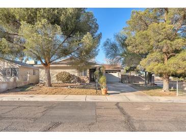 Charming single-story home with mature trees, a well-maintained yard, and an inviting facade at 5640 Vasila Dr, Las Vegas, NV 89110