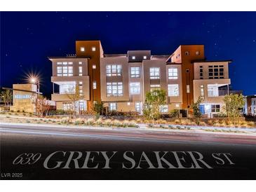 Modern three-story condo with large windows and stylish exterior lighting at twilight at 639 Grey Saker St, Las Vegas, NV 89138