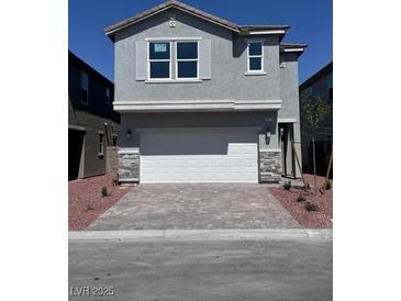 Beautiful two-story home featuring stone accents, a spacious two-car garage, and manicured landscaping at 6616 Bowery St, Las Vegas, NV 89148