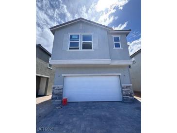 Charming two-story home featuring a two-car garage and stone accents for added curb appeal at 6616 Bowery St, Las Vegas, NV 89148