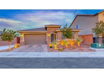 Charming single-story home featuring stone accents, a two-car garage, and desert landscaping at 7106 Stanley Frederick St, Las Vegas, NV 89166