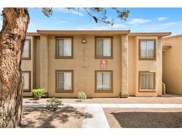 Inviting condo building with well-maintained landscaping and neutral color palette at 7300 Pirates Cove Rd # 1062, Las Vegas, NV 89145