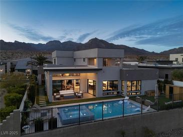 Contemporary home featuring a pool, outdoor seating, and views of the mountains at 826 Willits St, Las Vegas, NV 89138