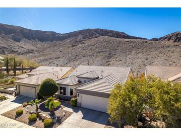 Inviting single-story home featuring desert landscaping, a two-car garage, and a tile roof at 2035 King Mesa Dr, Henderson, NV 89012