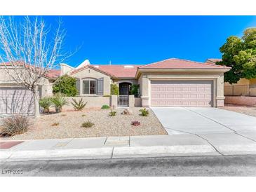 Charming single-story home featuring desert landscaping, a tile roof, and an attached two-car garage at 2702 Grand Forks Rd, Henderson, NV 89052