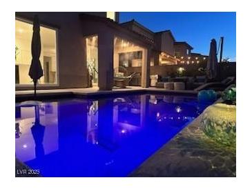 Inviting pool with lounge area, perfect for relaxing evenings and outdoor entertaining at 4138 Bayley Skye Ave, Las Vegas, NV 89141