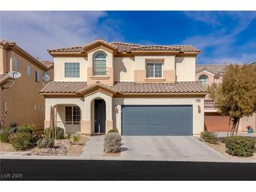 Two-story home featuring a tiled roof, two-car garage, and low-maintenance landscaping at 5596 Danforth Ave, Las Vegas, NV 89141