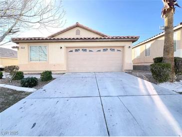 Charming single-story home featuring a two-car garage and low maintenance desert landscaping at 5829 Aqua Verde St, North Las Vegas, NV 89031