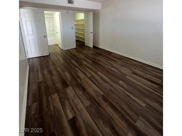 The bedroom features a closet with storage and wood-look flooring at 595 S Royal Crest Cir # 20, Las Vegas, NV 89169