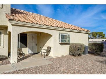 Charming single-story home featuring a cozy front porch area with desert landscaping and a tiled roof at 691 Anne Ln # 0, Henderson, NV 89015