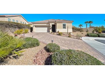 Charming single-story home featuring a desert landscape, paved driveway, and a two-car garage at 746 Royal Course Ct, Las Vegas, NV 89148