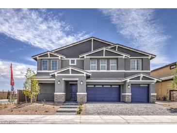 Beautiful two-story home featuring a three-car garage, gray paint, and a paved driveway in a suburban neighborhood at 7812 Alola Springs Ln # Lot 1, North Las Vegas, NV 89084