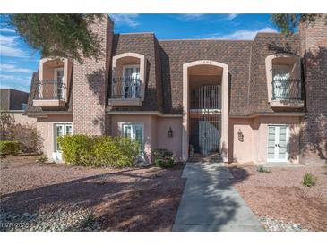 Charming townhouse with brick accents, dormer balconies, and a well-manicured front yard at 1301 E St Louis Ave # C, Las Vegas, NV 89104