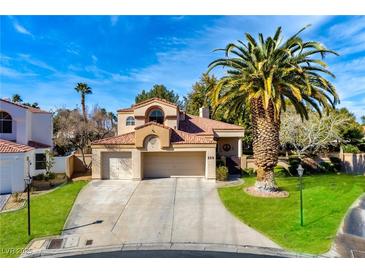 Inviting two-story home features a three-car garage, tile roof, and mature landscaping at 229 Drysdale Cir, Henderson, NV 89074