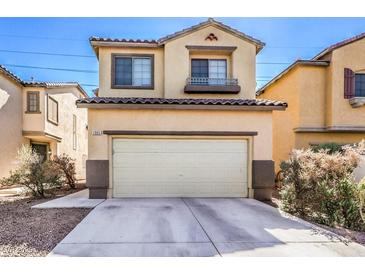 Two-story home featuring a two-car garage, neutral colors, and desert landscaping at 2865 Vigilante Ct, North Las Vegas, NV 89081