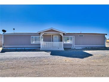 Charming single-story home featuring a covered front porch and neutral exterior paint at 3581 W Dyer Rd, Pahrump, NV 89048