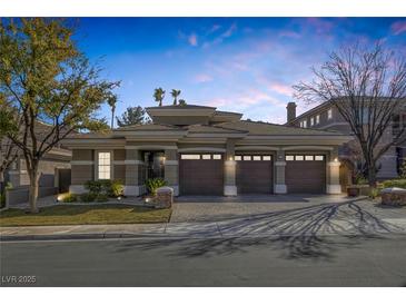 Stunning one-story home with a three-car garage and beautifully landscaped front yard at 420 Pinnacle Heights Ln, Las Vegas, NV 89144