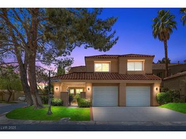 Charming two-story home featuring a tile roof, attached two-car garage, and professionally landscaped front yard at 4961 Tierra Del Sol Dr, Las Vegas, NV 89113